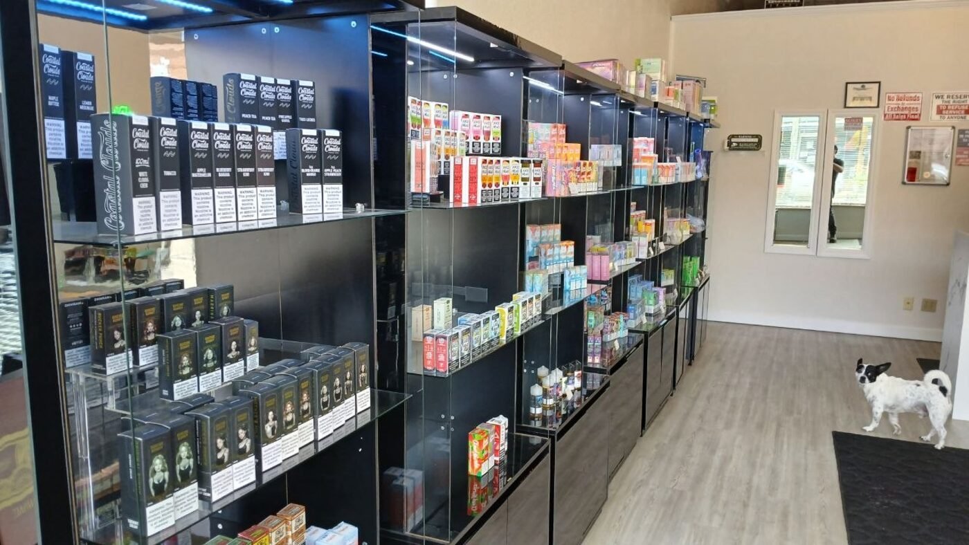 Wall of vape and e-liquid display cases at High Society
